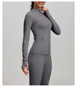 Close-up detail of a slim-fit gray sports yoga jacket featuring thumb holes and stand collar