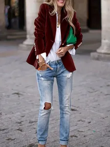 Stylish burgundy velvet slim-fit blazer for women paired with ripped jeans for a chic look.