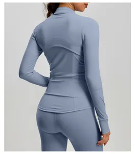 Detailed back view of periwinkle blue slim fit yoga jacket with peach stitching