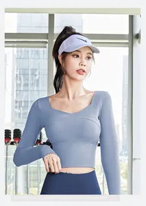 Close-up view of blue long-sleeved cropped yoga top featuring a stylish cross V-neck