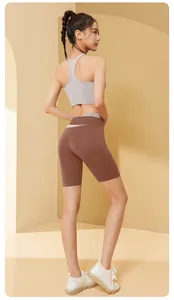 Detailed back view of brown high-waist yoga shorts and grey sports bra on Asian model