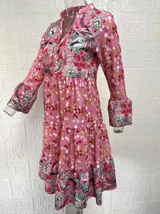 Side view of pink floral V-neck tiered dress with ruffled long sleeves shown on mannequin