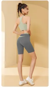 Detail of seamless color-block yoga set with racerback bra and high-waist shorts.