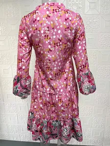Back view of stylish pink floral long-sleeved V-neck dress with layered bell sleeves