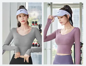 Detailed view of women's long-sleeve cropped yoga top with chest pads in grey and purple colors