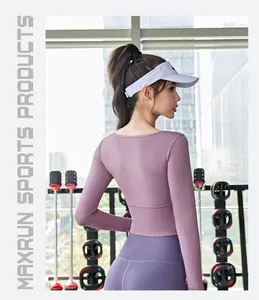 Detailed back view of a purple long-sleeve crop top yoga shirt on an athletic woman