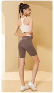 Back view of a two-piece yoga set featuring a beige sports bra and brown biker shorts