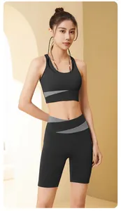 Two-piece black and grey color-block yoga set featuring high-waist shorts on model