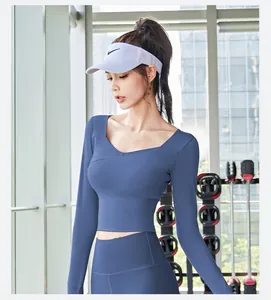 Close-up of blue long-sleeve crop yoga top with built-in pads for professional fitness gym