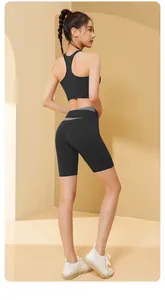 Back view of a high-performance black two-piece workout set with contrast waistband