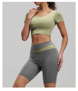 Close-up of color-blocked yoga set featuring cross-over waist shorts and crop top