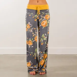Detail of comfortable high-waisted floral wide-leg lounge pants with yellow drawstring