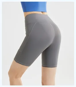 Close-up of high-waisted yoga shorts with side pockets and striped detail in gray