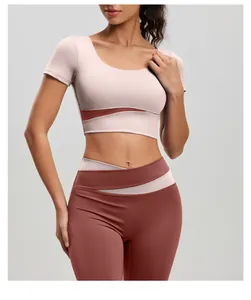 Two-piece color-block yoga set featuring a short sleeve crop top and high-waisted leggings