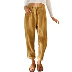 Detail showing high-waisted khaki casual trousers with pockets and rolled cuffs