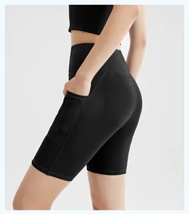 Detail of black high-waisted yoga shorts featuring a functional ribbed side pocket