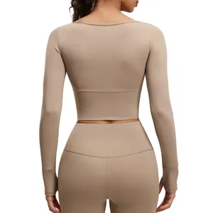 Professional back view of beige long-sleeve cropped yoga top and high-waist leggings