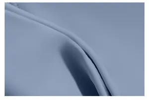 Macro view of soft, light blue yoga fabric showing fine knit texture and naked feel