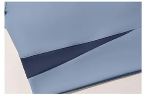 Detailed close-up showing high-quality stitching and fabric texture of color-block yoga top