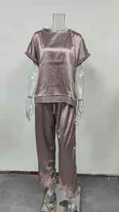 Detail view of mauve satin two-piece set with loose shirt and wide-leg trousers.