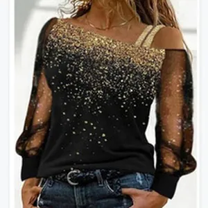 Close-up of elegant black blouse featuring gold glitter and sheer mesh sleeves