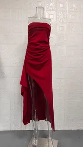 Detail of red tube top maxi dress featuring high slit and ruched fabric texture