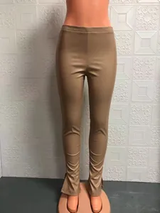 Slim fit PU leather pants with split hem detail and mid-rise elastic waist for women.