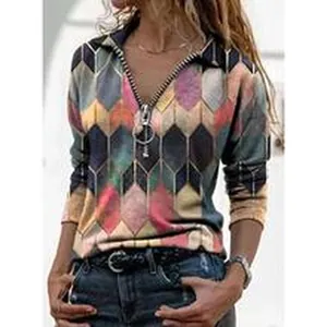 Detailed close-up showing geometric diamond pattern and large O-ring zipper on long sleeve top.