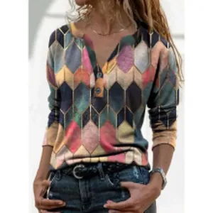 Close-up of geometric hexagon pattern and button V-neck on long sleeve top