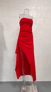 Detailed view of a vibrant red strapless ruched maxi dress featuring a high side slit