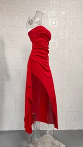 Side detail view of a sexy red strapless maxi dress with high slit and ruched design