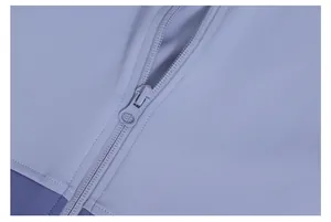 Close-up detail of a high-quality zipper on a light purple patchwork yoga jacket