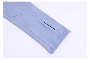 Detailed macro view of athletic yoga jacket sleeve cuff with functional thumbhole design