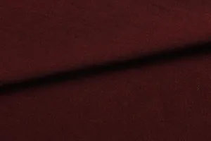 Macro view showing the fine knit texture of the burgundy women's t-shirt fabric.