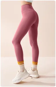 Dusty rose high-waisted yoga pants on model, showing seamless fit and sleek design.