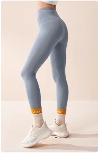 Detail view of high-waisted seamless fleece-lined yoga leggings in a soft blue shade