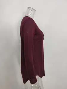 Side view of burgundy V-neck long sleeve T-shirt with black lace-up tie detail.
