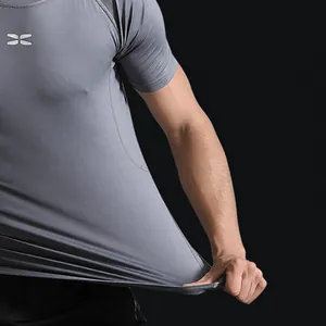 Breathable grey compression t-shirt for men showing high elasticity sports fabric