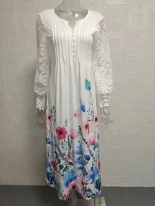Detail of elegant white dress with lace sleeves and floral print.