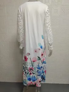 Back view of a white long-sleeve dress featuring floral prints and delicate lace sleeves.