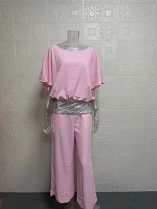 Pink two-piece set featuring sequin trim and batwing top shown on a mannequin