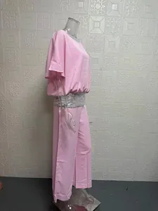 Side profile of pink two-piece set with silver sequin batwing top and wide-leg pants