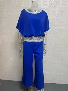 Detailed view of women's blue batwing top and wide leg pants set with silver sequins