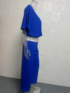 Side view of blue batwing top with silver sequins and matching wide-leg trousers