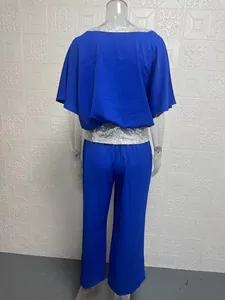 Back view of blue set featuring silver sequin trim on batwing sleeve top and pants