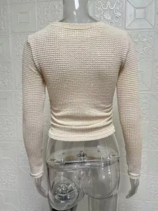 Rear view of a beige slim fit long sleeve knitted top on a clear mannequin