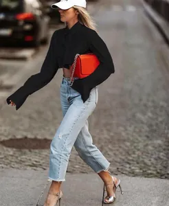 Straßenstil-Detail eines schwarzen langärmeligen bauchfreien Hemdes für Herbstmode Damen