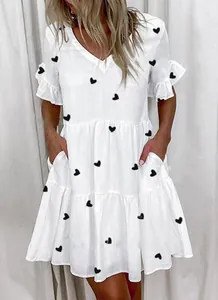 Detail view showing the tiered design and heart print of this stylish white summer dress
