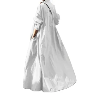 Back view of a white loose long sleeve cotton linen ethnic maxi dress with wide hem