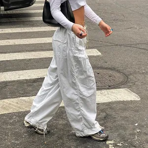 Street style detail of white low waist cargo wide leg pants with drawstring cuffs